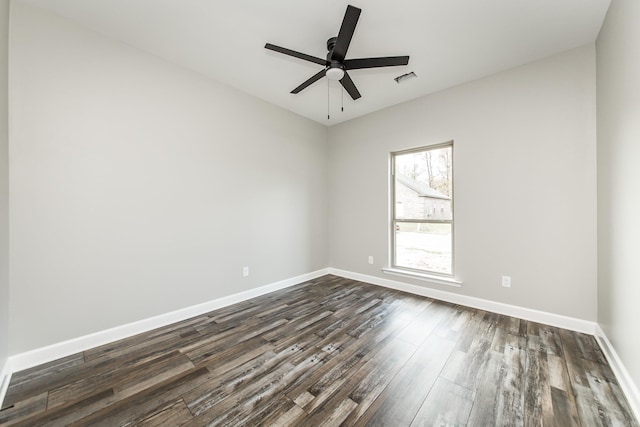 spare room featuring ceiling fan and dark wood-type flooring