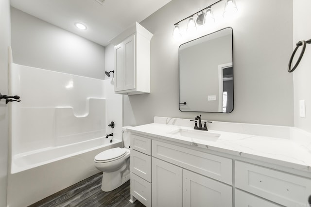 full bathroom with vanity, shower / bathtub combination, toilet, and wood-type flooring