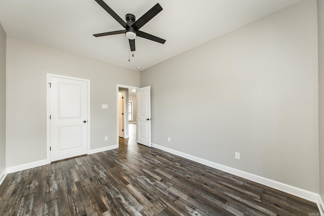 unfurnished bedroom with ceiling fan and dark hardwood / wood-style floors