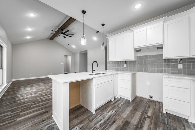 kitchen with white cabinets, kitchen peninsula, ceiling fan, and sink