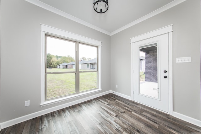 unfurnished dining area featuring dark hardwood / wood-style flooring and crown molding