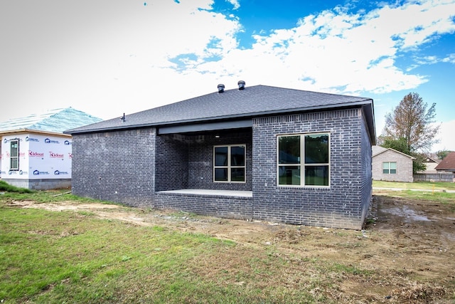 view of property exterior with a yard and a patio area