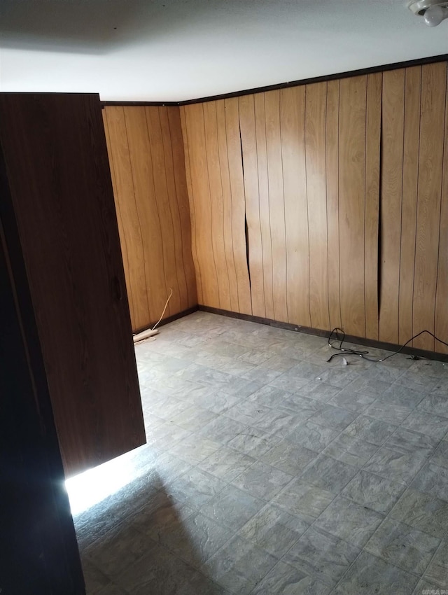 spare room with wood walls