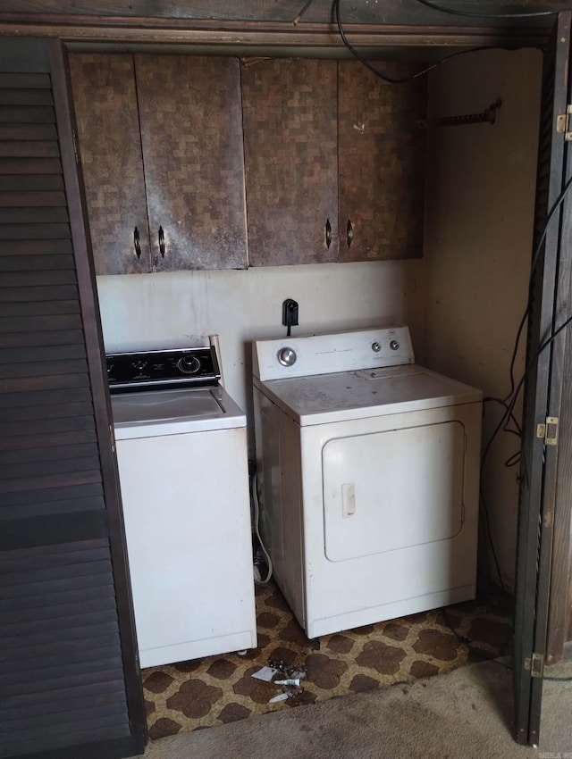 washroom with cabinets and washing machine and dryer