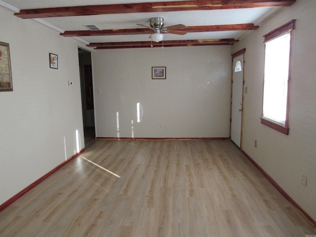 spare room featuring beamed ceiling, ceiling fan, and light hardwood / wood-style floors