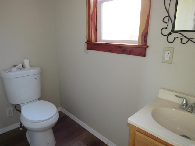 bathroom with hardwood / wood-style flooring, vanity, and toilet