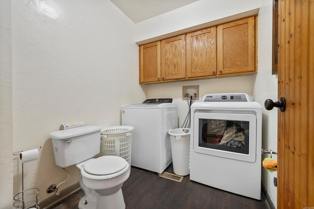 clothes washing area with dark wood-type flooring and washing machine and clothes dryer