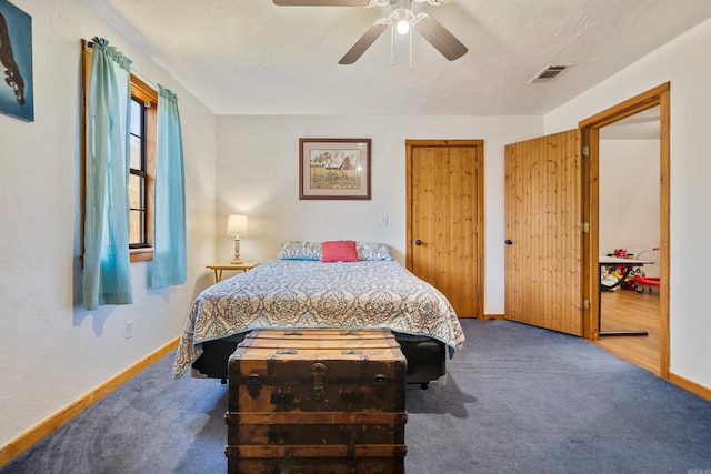 carpeted bedroom with two closets and ceiling fan