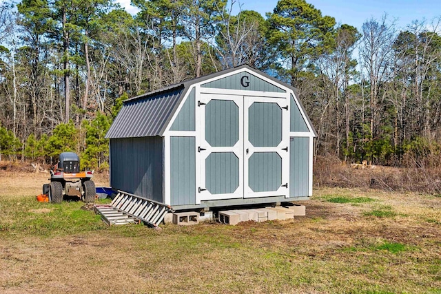 view of outbuilding featuring a lawn