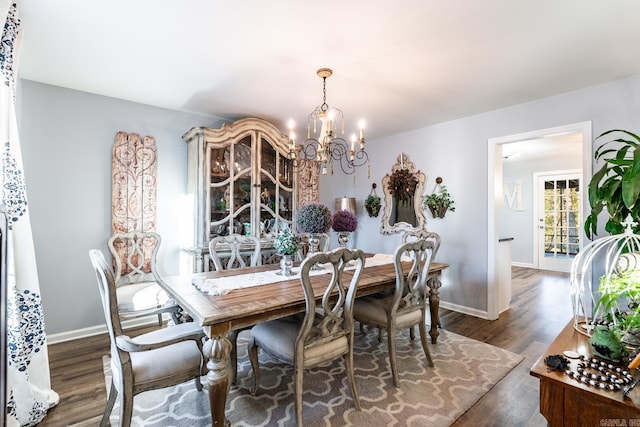 dining space with a chandelier and dark hardwood / wood-style flooring