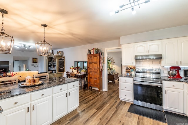 kitchen with pendant lighting, decorative backsplash, white cabinets, and stainless steel electric range oven