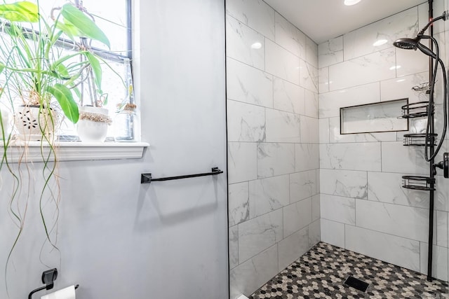 bathroom with tiled shower