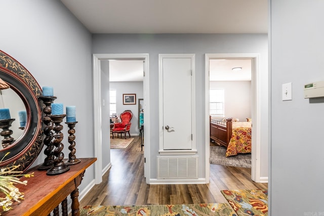 corridor with dark hardwood / wood-style flooring