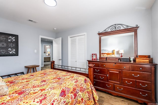 bedroom with light hardwood / wood-style flooring and a closet