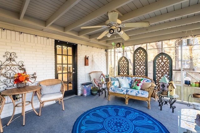 sunroom / solarium with beamed ceiling and ceiling fan