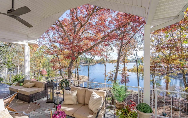 exterior space featuring ceiling fan and a water view