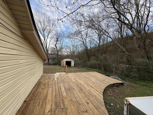 wooden deck featuring a storage unit