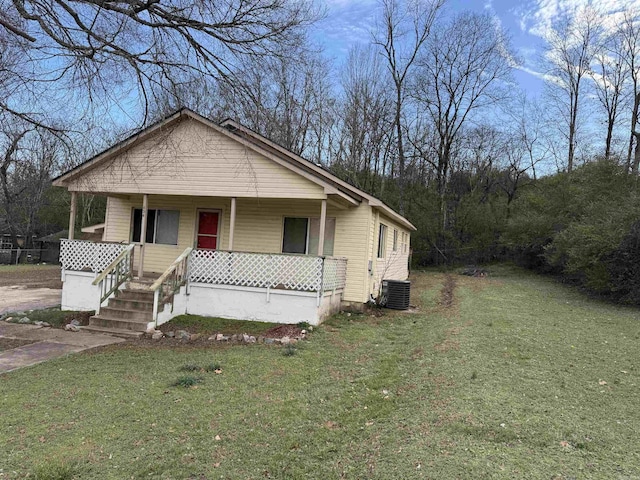 bungalow-style home featuring a porch, a front yard, and central AC