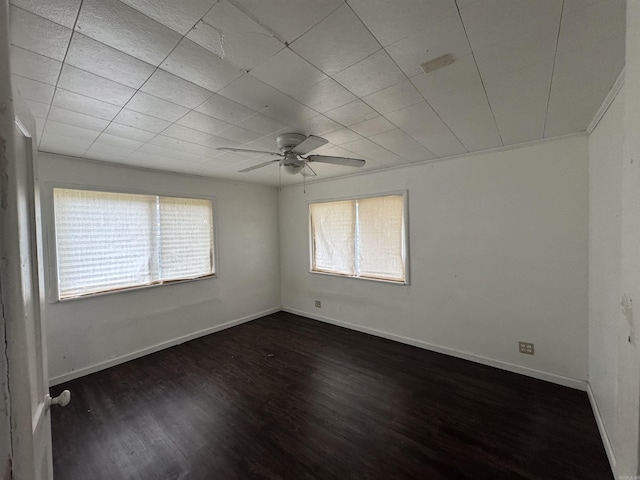 spare room with dark hardwood / wood-style floors and ceiling fan