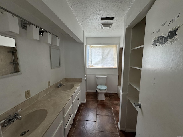 bathroom with vanity, toilet, a textured ceiling, and a washtub