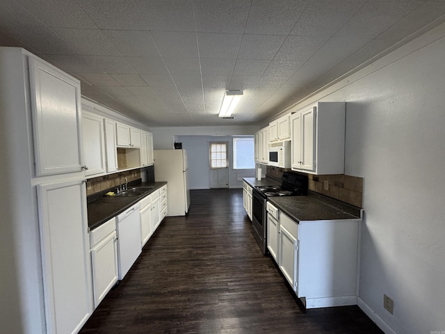 kitchen featuring white cabinets, white appliances, dark hardwood / wood-style floors, and sink