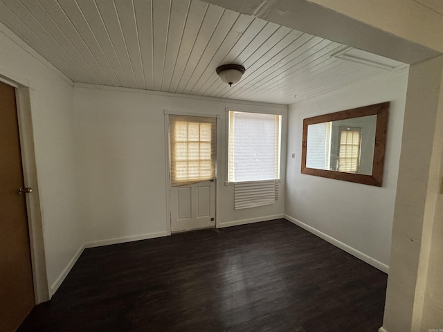 empty room featuring crown molding, wood ceiling, and dark hardwood / wood-style floors