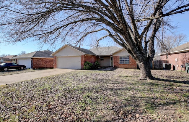 ranch-style house with central AC and a garage