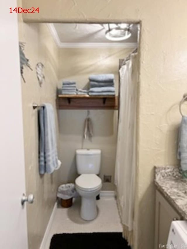 bathroom featuring vanity, toilet, and crown molding