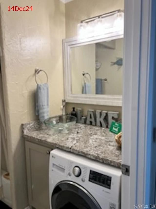 interior space with vanity and washer / clothes dryer