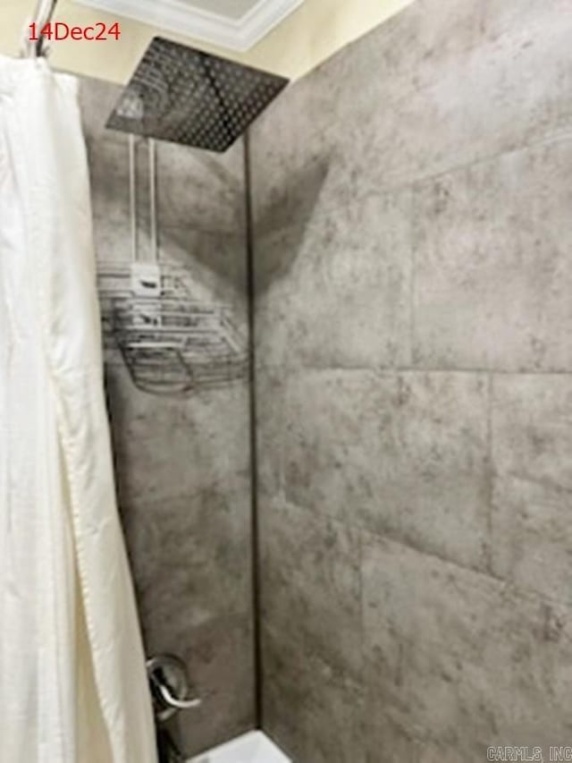 bathroom with curtained shower and ornamental molding