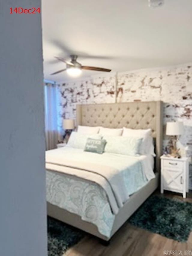 bedroom with ceiling fan and hardwood / wood-style flooring