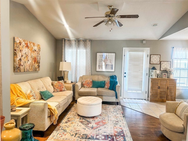 living room with hardwood / wood-style floors, ceiling fan, and vaulted ceiling