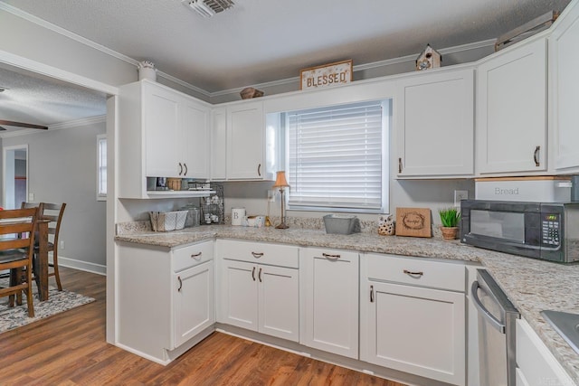 kitchen featuring dark hardwood / wood-style flooring, white cabinets, stainless steel dishwasher, and a textured ceiling