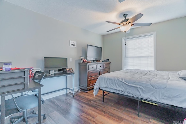 bedroom featuring a textured ceiling, ceiling fan, and dark wood-type flooring