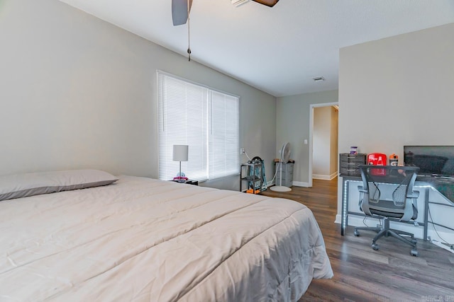 bedroom with ceiling fan and dark hardwood / wood-style floors