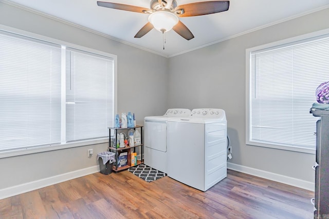 washroom with hardwood / wood-style floors, independent washer and dryer, ornamental molding, and a wealth of natural light