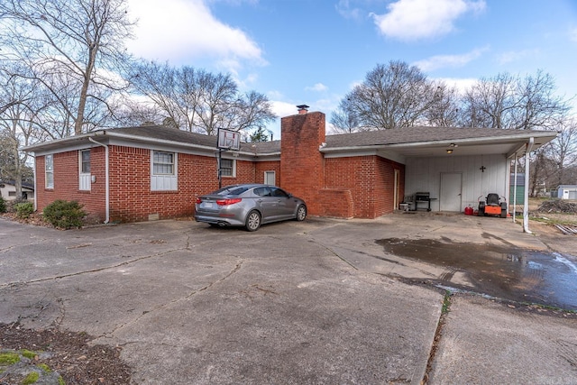 view of side of property with a carport