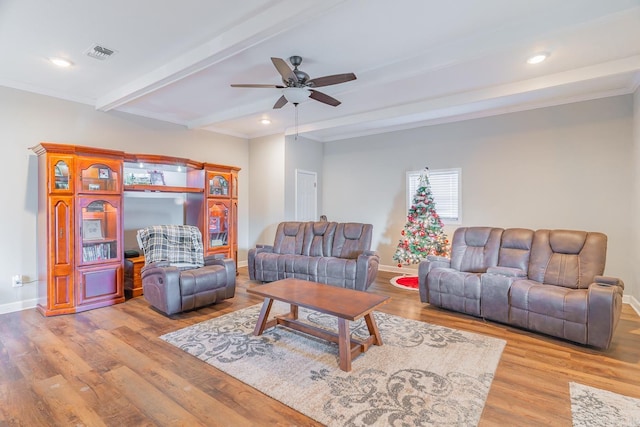 living room with beam ceiling, light hardwood / wood-style floors, ceiling fan, and ornamental molding