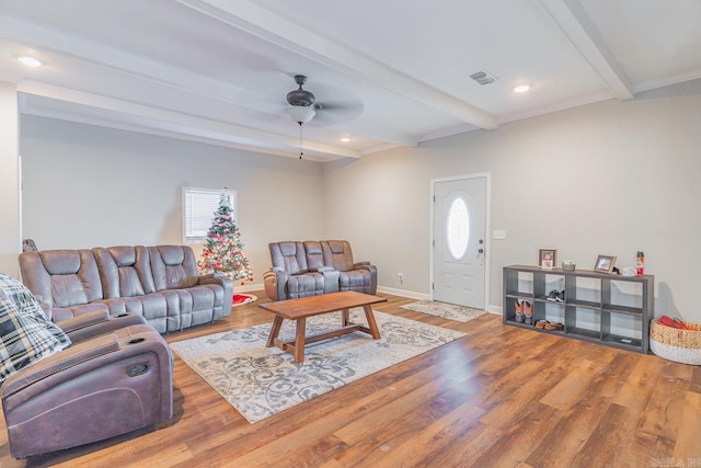 living room featuring beamed ceiling, ceiling fan, and hardwood / wood-style floors