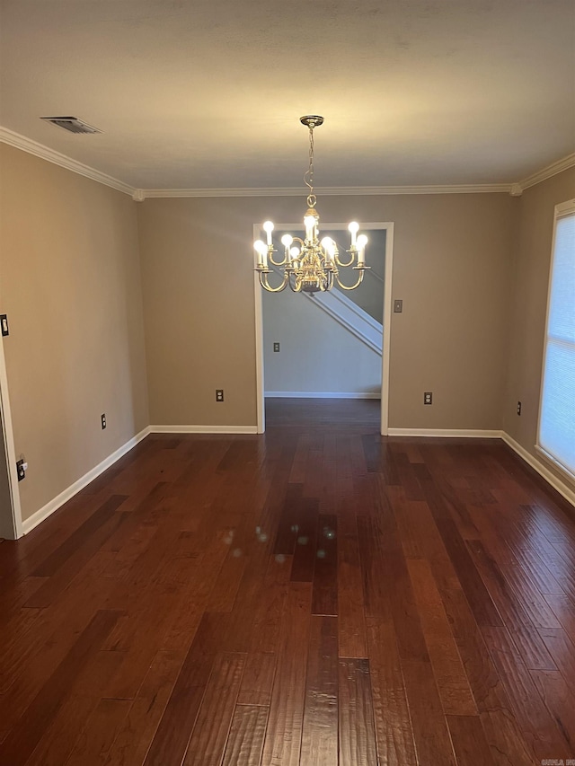 unfurnished dining area featuring ornamental molding, dark hardwood / wood-style floors, and an inviting chandelier