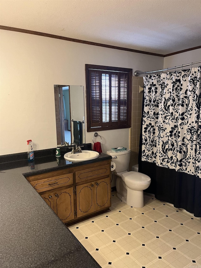 bathroom featuring crown molding, vanity, a textured ceiling, and toilet