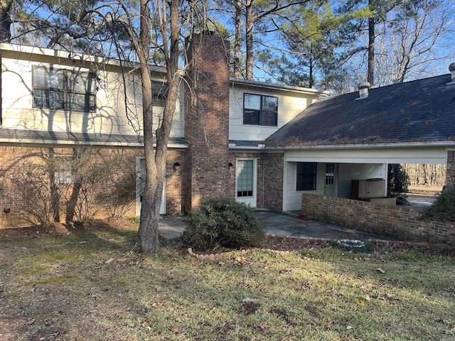 back of house featuring a yard and a patio