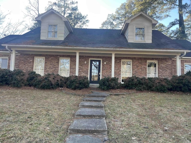 cape cod-style house with a porch and a front yard