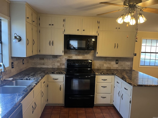 kitchen featuring dark stone counters, black appliances, sink, ceiling fan, and kitchen peninsula