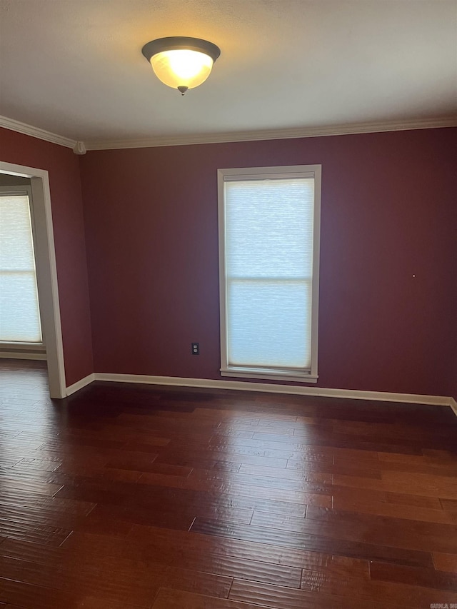 unfurnished room featuring dark hardwood / wood-style flooring, plenty of natural light, and ornamental molding