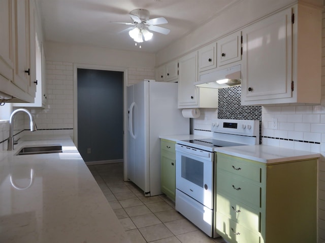 kitchen featuring sink, white appliances, white cabinetry, light tile patterned flooring, and decorative backsplash