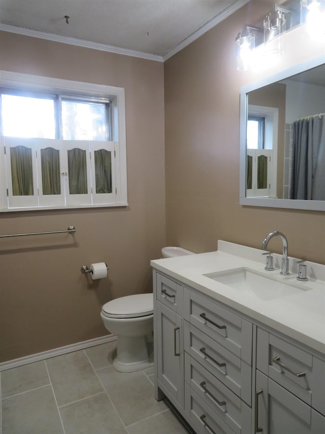 bathroom featuring tile patterned flooring, vanity, crown molding, and toilet