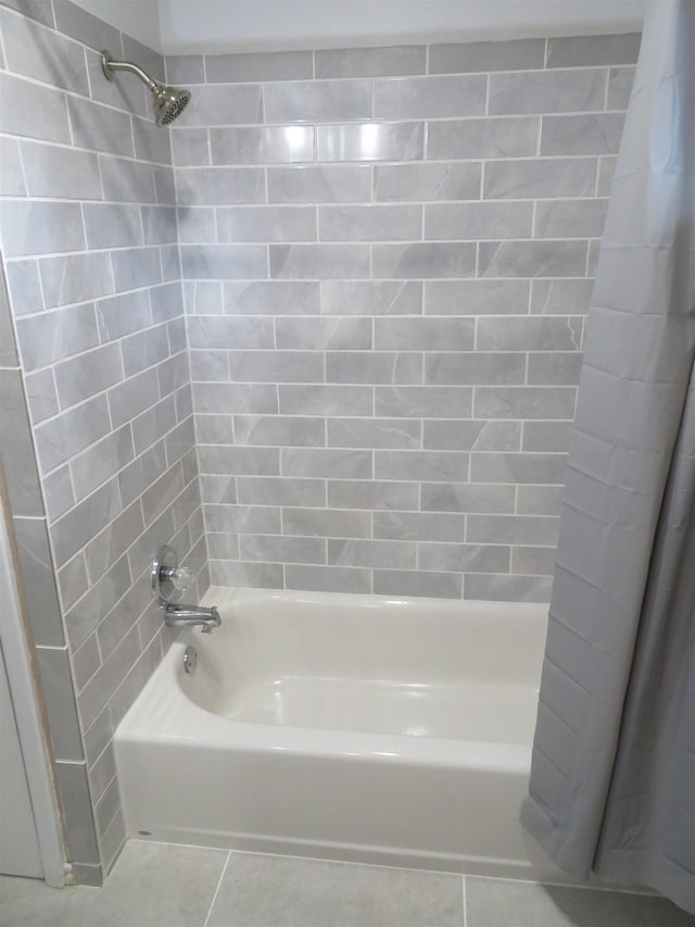 bathroom with tile patterned floors and shower / tub combo