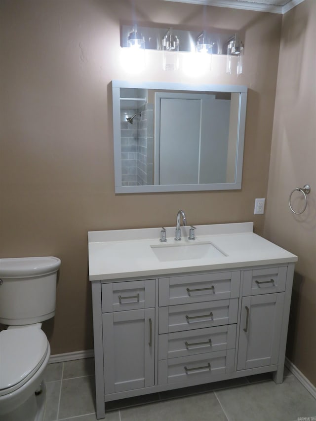 bathroom with tile patterned flooring, vanity, and toilet