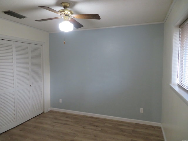 2043 Elaine Cir, Arkadelphia, AR 71923 - unfurnished bedroom with ornamental molding, wood finished floors, a closet, baseboards, and ceiling fan